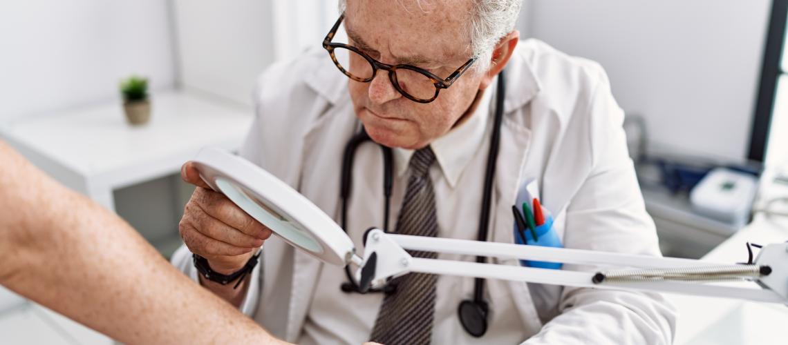 Médico examinando pele de paciente
